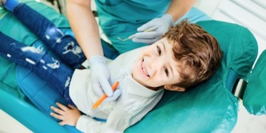 Family dentist at Dentistry On Sinclair examining child's teeth during preventive checkup