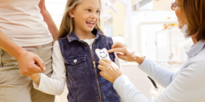 Family dentist in Acton at Dentistry On Sinclair examining child's teeth during first visit