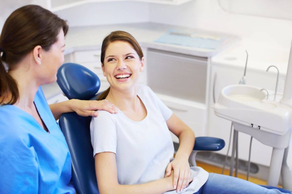 Patient speaking with a dental professional while choosing a dentist in Georgetown or Acton